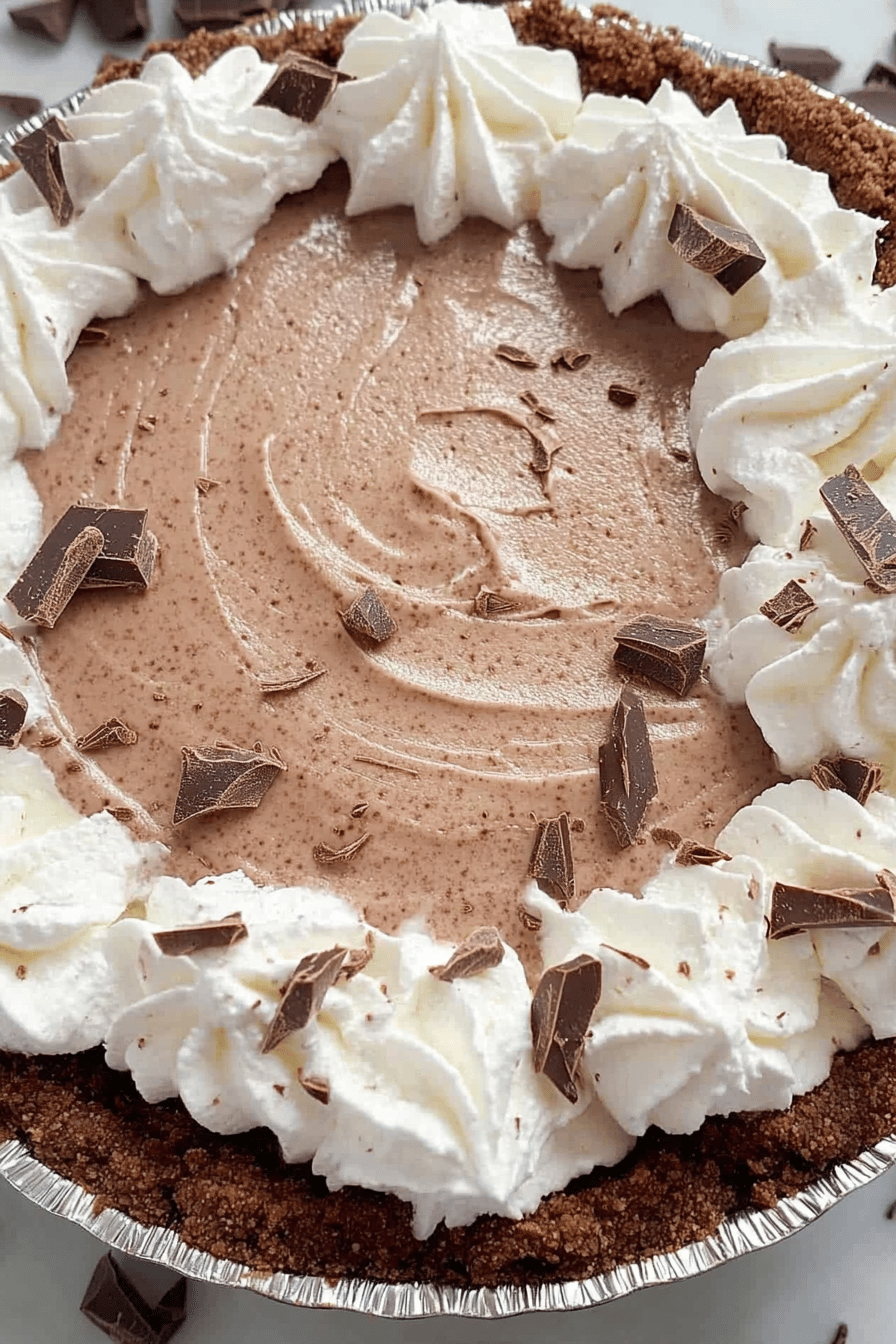 No-Bake Chocolate Cream Pie slice on plate showing perfect texture and swirl pattern